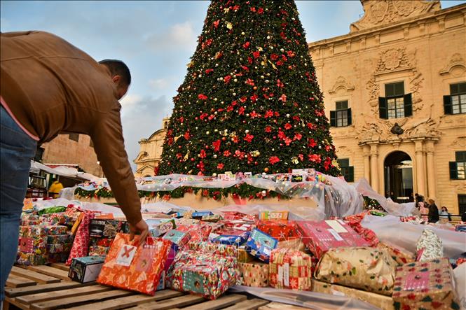 Người dân quyên góp quà Giáng sinh cho các em nhỏ có hoàn cảnh khó khăn tại Valletta, Malta. Ảnh: THX/TTXVN
