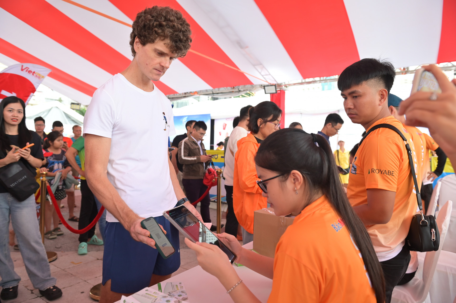 A foreign runner showing his registration to receive running kit

