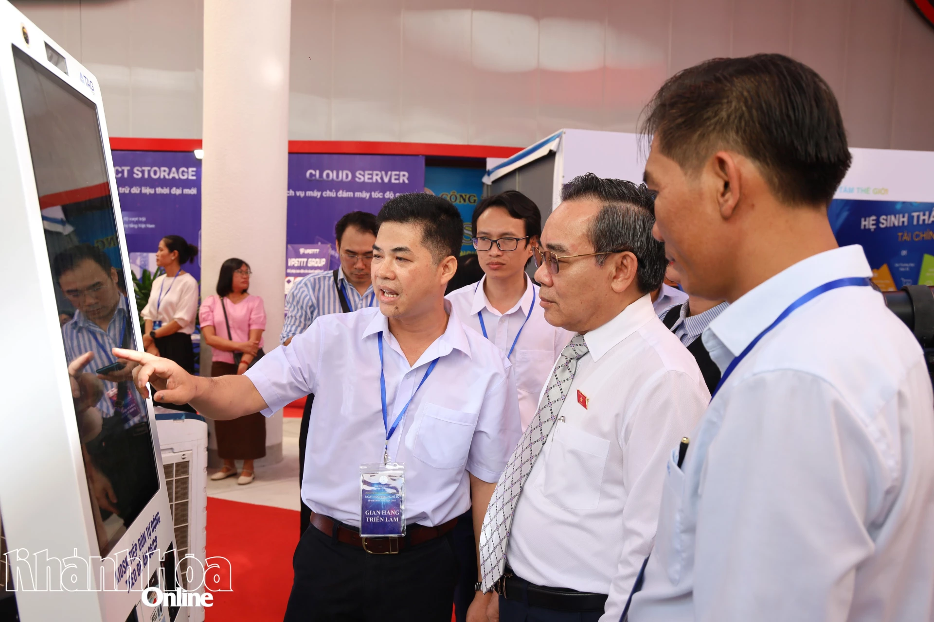 Đại biểu nghe hướng dẫn sử dụng kiok tiếp đón tự động theo Đề án 06. 