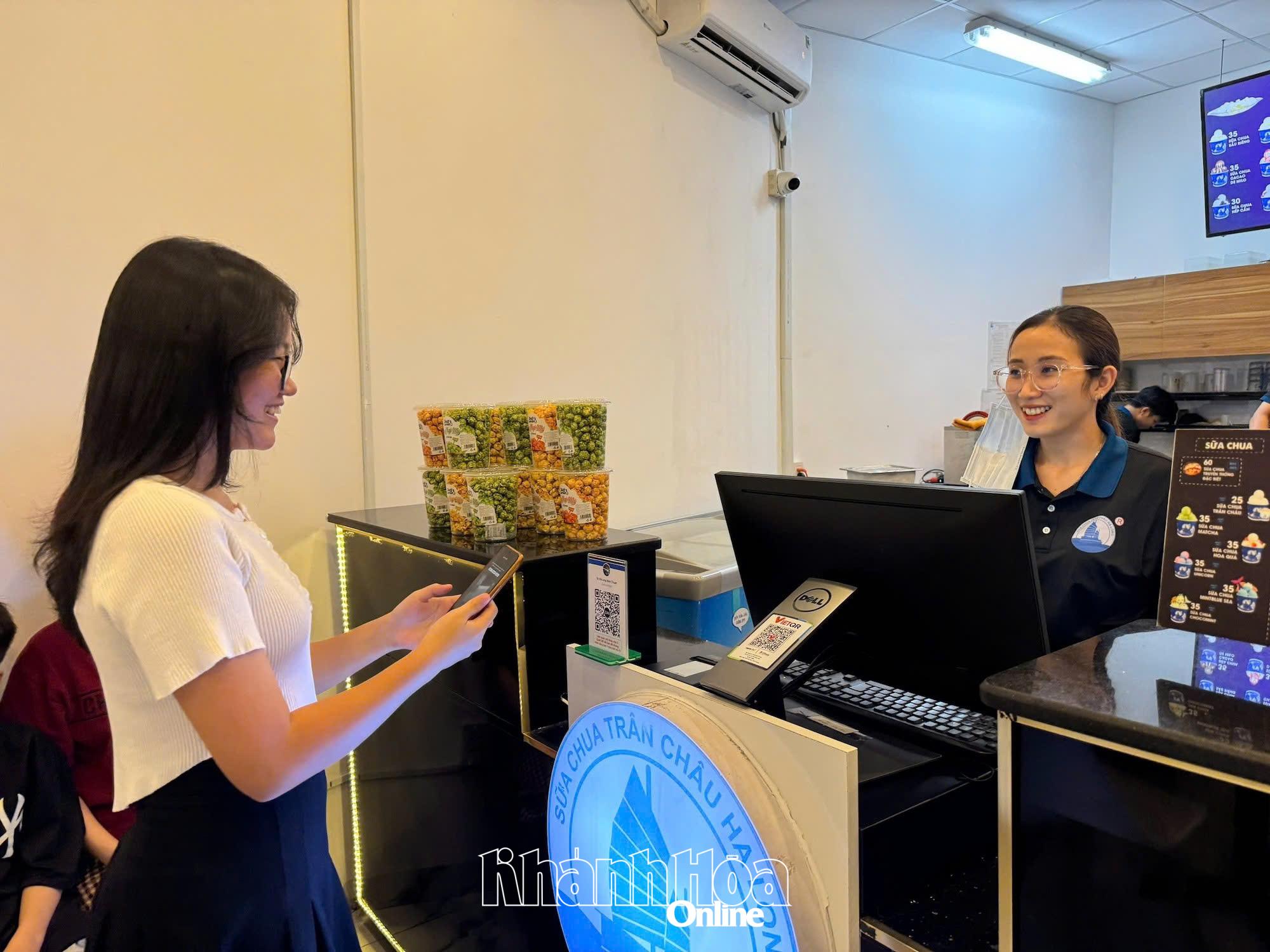 Khách hàng thanh toán không dùng tiền mặt khi mua hàng tại một cửa hàng ở phường Phan Rang.