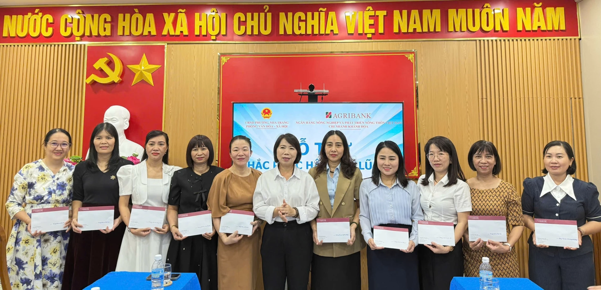 Bà Lâm Thị Hồng - Phó Giám đốc Agribank Chi nhánh Khánh Hòa trao hỗ trợ cho đại diện các trường học trên địa bàn phường Nha Trang. 