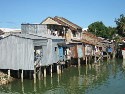 Mỗi ngày, dòng sông Cái Nha Trang lại thêm “gánh nặng” ô nhiễm từ những khu nhà chồ như thế này (Ảnh chụp khu nhà chồ dưới chân cầu Hà Ra, phường Vĩnh Phước).