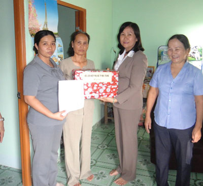  Đại diện Hội Liên hiệp Phụ nữ thành phố tặng quà cho bà Xăn tại buổi lễ bàn giao nhà.