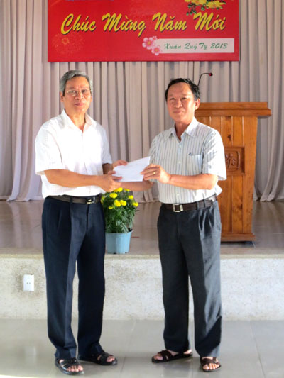  Thay mặt Đoàn đại biểu Quốc hội tỉnh, ông Lê Tuấn Tứ (bên trái) trao quà Tết cho lãnh đạo Làng SOS.