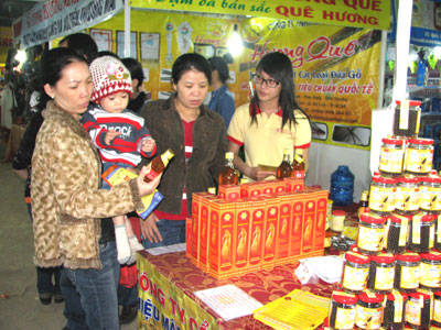 Khách hàng chọn mua mật ong tại hội chợ. 