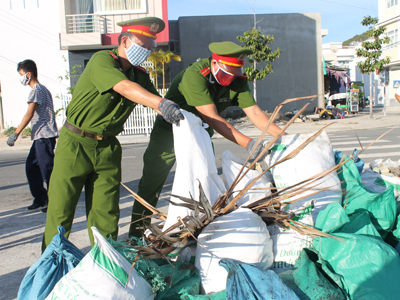 Các anh Phòng Cảnh sát Môi trường Công an tỉnh Khánh Hòa tham gia dọn vệ sinh. 