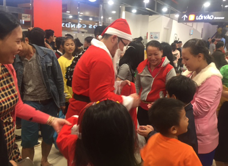 Santa Claus presenting gifts to people at Lotte Mart Nha Trang.