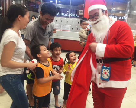 Children show happiness receiving presents from Santa Claus.