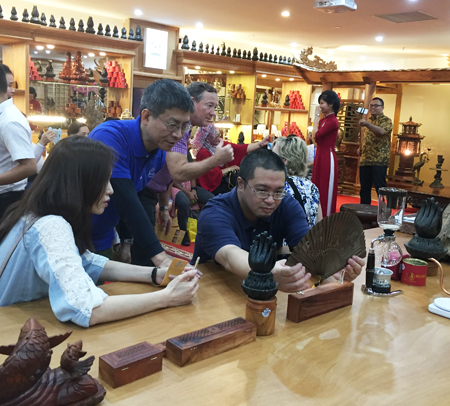 Contemplating products made of agarwood.