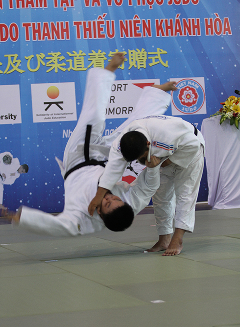Judokas performing judo at ceremony.