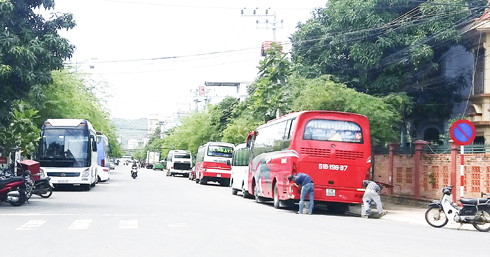 Bất chấp biển cấm (bên phải), hàng ngày garage Thanh Lâm cho đậu nhiều xe ô tô dưới lòng đường  để công nhân sửa chữa. (Ảnh chụp trưa 27-7)