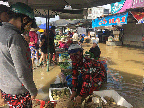 Tiểu thương chợ Vĩnh Trung buôn bán trong cảnh ngập lụt