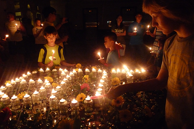 Tourists lighting candles during Earth Hour in Nha Trang