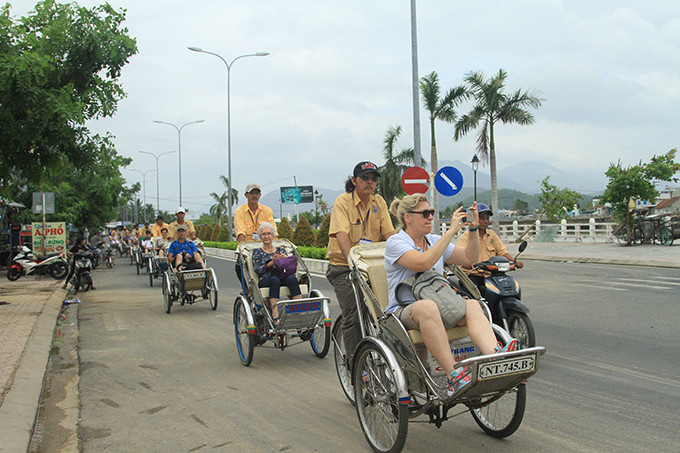 Du khách tham quan TP.Nha Trang bằng xe xích lô. 