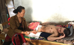 Elderly mother taking care of her paralyzed adult son