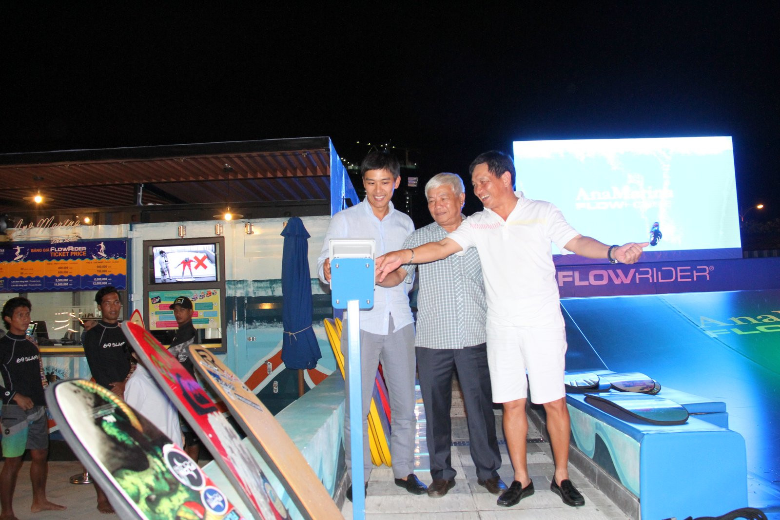 Representatives pressing launching button at opening ceremony of Ana Marina Flowhouse