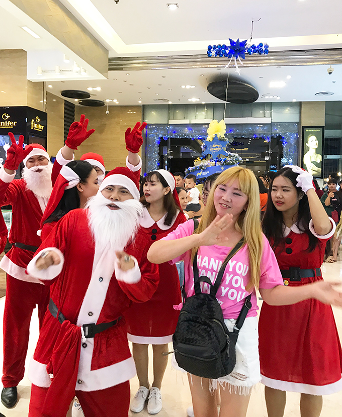 Foreign tourist dancing with Santa Claus