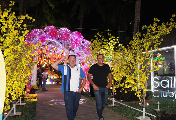 Franky and Johny, tourists from Australia, feel interested in Tet atmosphere in Nha Trang.