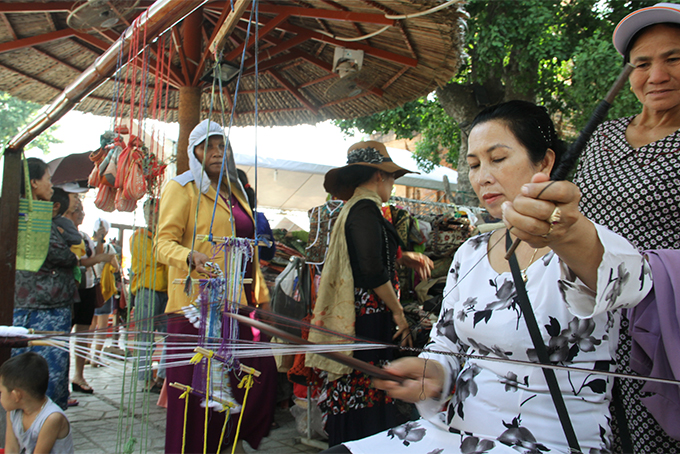 Cham people performing brocade making techniques