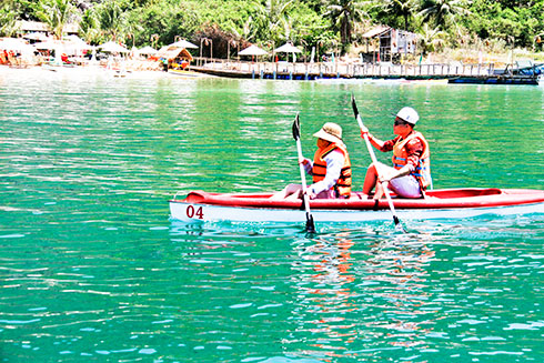 Tourist rowing kayak on Robinson island
