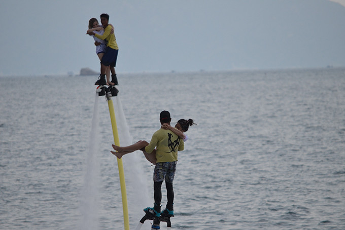 Female tourists experiencing flyboard riding 