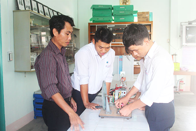 Thầy Phạm Công Út hướng dẫn nhóm học sinh thực hiện đề tài khoa học kỹ thuật. 