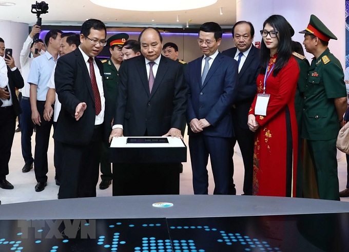 Thủ tướng Nguyễn Xuân Phúc và các đại biểu thăm quan gian hàng trưng bày các sản phẩm của Tập đoàn Viettel (ảnh TTXVN).