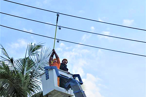 Nhân viên KHPC lắp thiết bị cảnh báo sự cố trên lưới điện.
