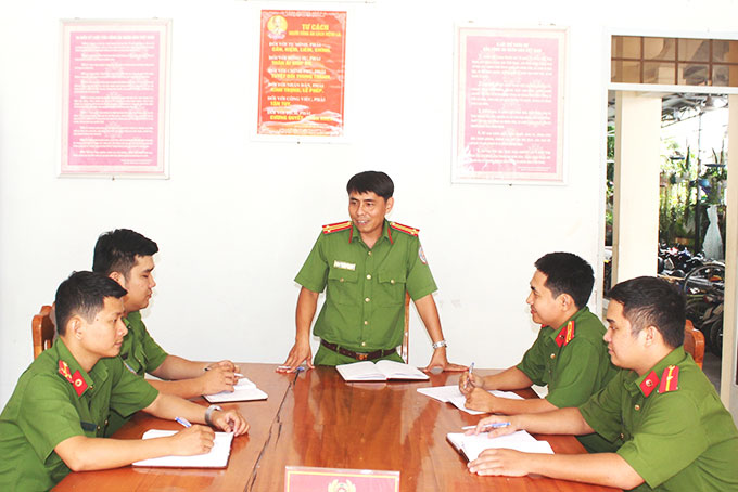 Trung tá Nguyễn Kiên Cường trao đổi nghiệp vụ với các đồng nghiệp. 
