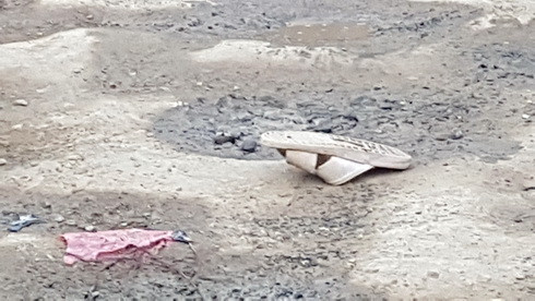Một chiếc dép của nạn nhân văng trên đường.