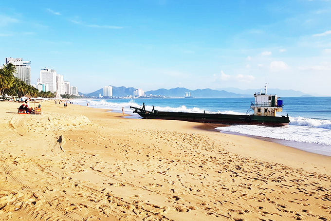 Chiếc sà lan bị hỏng máy nằm ngay trên bãi biển Nha Trang.
