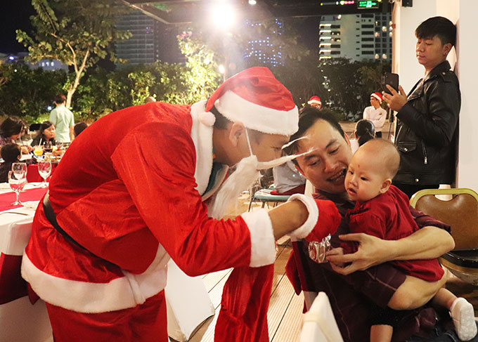 Santa Claus offering Christmas gift to a child