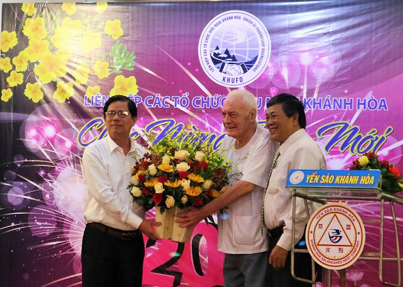 Ông Nguyễn Tấn Tuân tặng hoa cho đại diện những người bạn nước ngoài. 