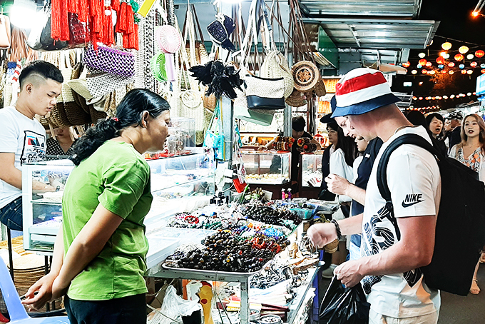 Khách du lịch mua hàng tại khu vực chợ đêm gần số 46 Trần Phú (TP. Nha Trang).