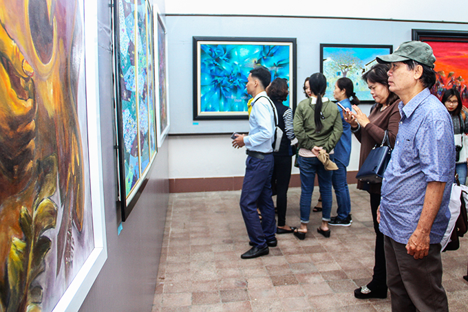 People contemplating paintings at Khanh Hoa’s fine art exhibition