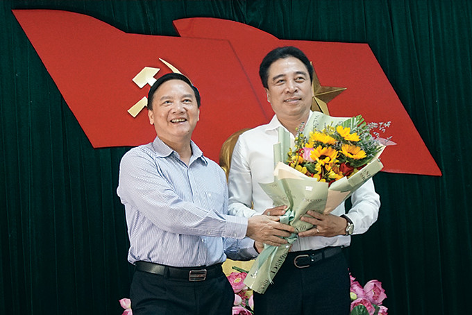Ông Nguyễn Khắc Định tặng hoa chúc mừng ông Nguyễn Khắc Toàn. 