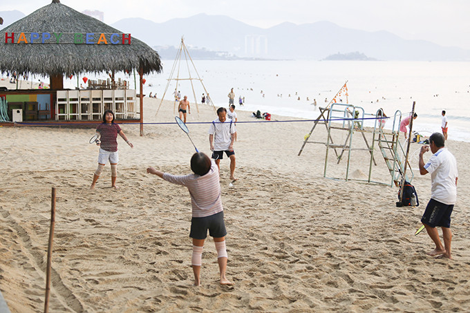Playing badminton on beach