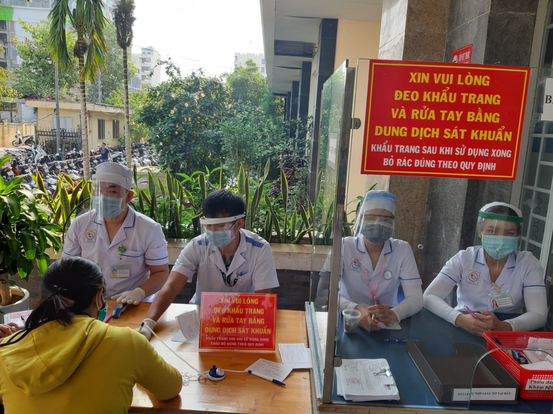 Cán bộ y tế Bệnh viện Đa khoa tỉnh Khánh Hoà hướng dẫn người đến bệnh viện khai báo y tế 