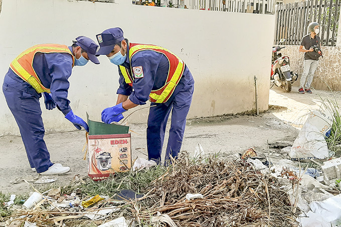 Công nhân vệ sinh môi trường thu gom rác ở khu vực tổ dân phố Ngọc Thảo. 