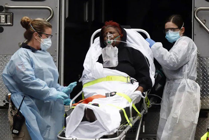 Đưa bệnh nhân Covid-19 ở New York (Mỹ) lên xe cấp cứu. Ảnh: Reuters.