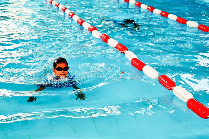 Children learning swimming at a pool in Nha Trang City