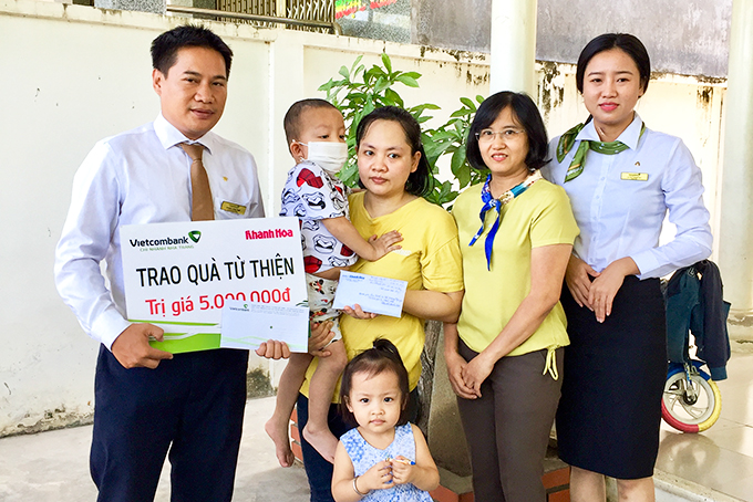 Đại diện Báo Khánh Hòa và Vietcombank Nha Trang trao tiền ủng hộ cho gia đình bé Bế Hoàng Nguyên.