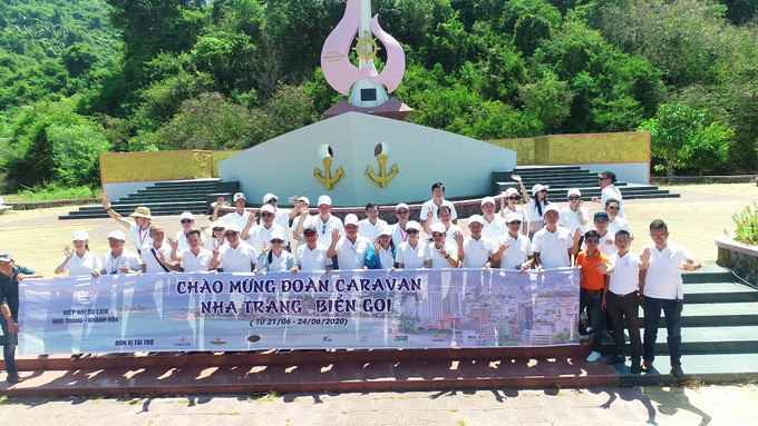 Caravan group posing for photo at “No-number” Ship Monument in Vung Ro, Phu Yen Province
