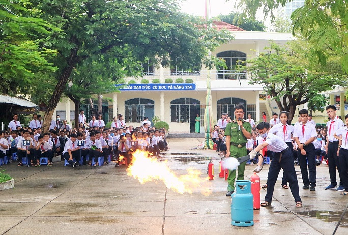 Học sinh thực hành sử dụng bình chữa cháy. 