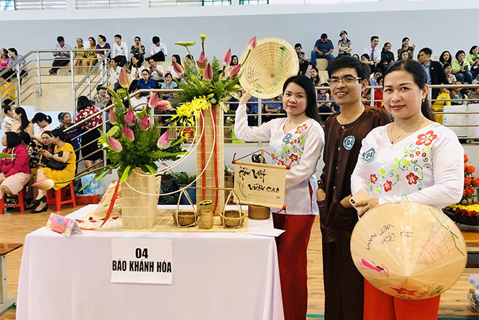 Khanh Hoa Newspaper team posing with their work