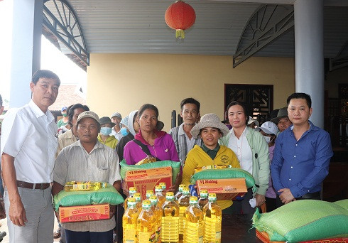 Đại diện đơn vị tài trợ và chính quyền địa phương trao quà cho các hộ dân xã Diên Tân.