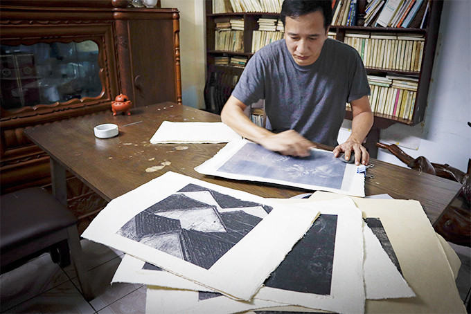 Nghệ sĩ nhiếp ảnh Trần Hải Bình thực hiện thao tác in ảnh lên giấy dó và  những tác phẩm nhiếp ảnh in trên giấy dó đầu tay của anh (ảnh bên). 