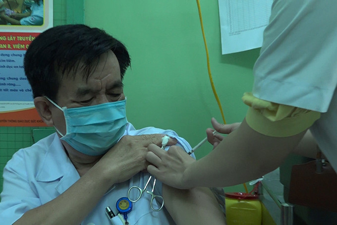 Bác sĩ Nguyễn Đông – Giám đốc Bệnh viện Bệnh nhiệt đới tỉnh đang tiêm vắc xin Covid-19