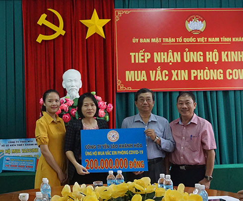 Đại diện Công ty TNHH Nhà nước Một thành viên Yến sào Khánh Hòa (thứ 2 từ trái sang) trao ủng hộ mua vắc xin phòng Covid-19.