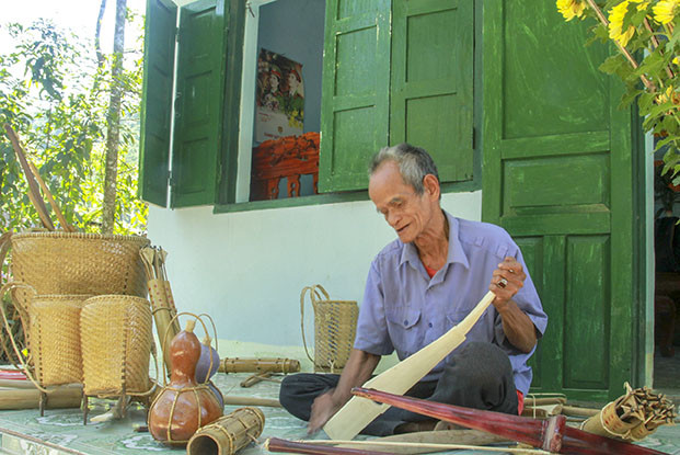 Raglai person in Khanh Son District making labor tools